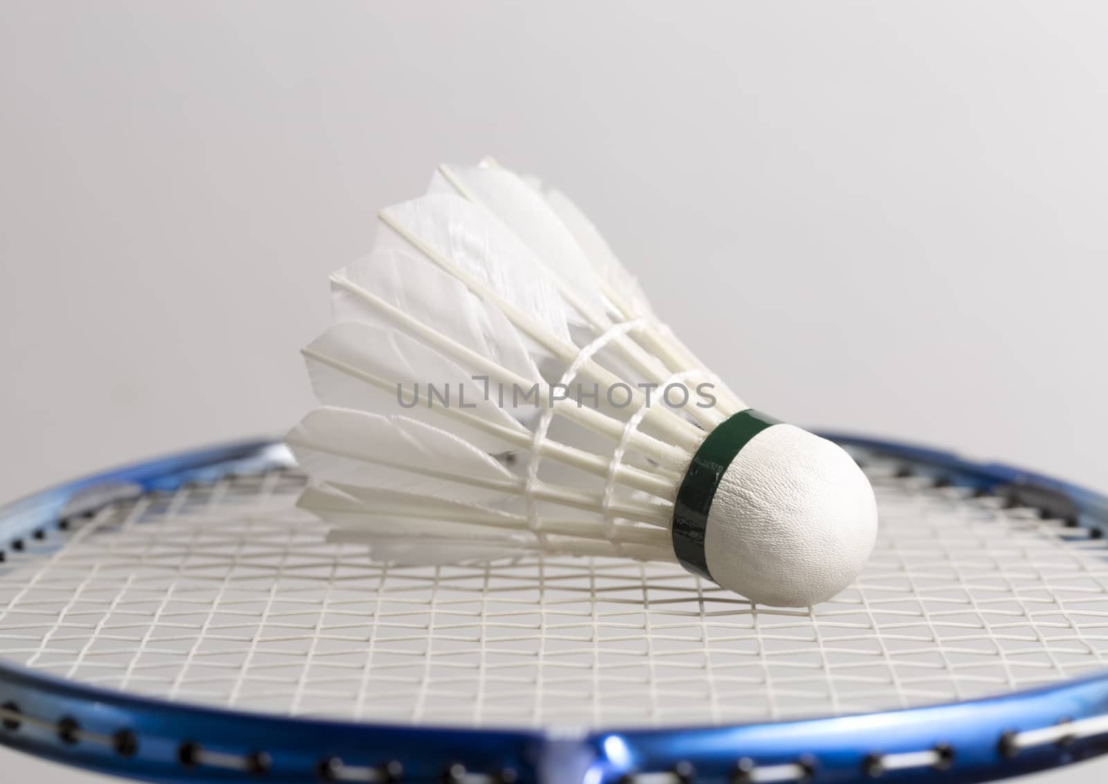 Shuttlecock on Badminton Racket close up.