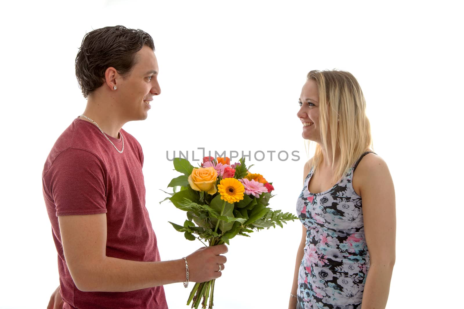 Girl is happy with bouquet of flowers giving by boyfriend over white background