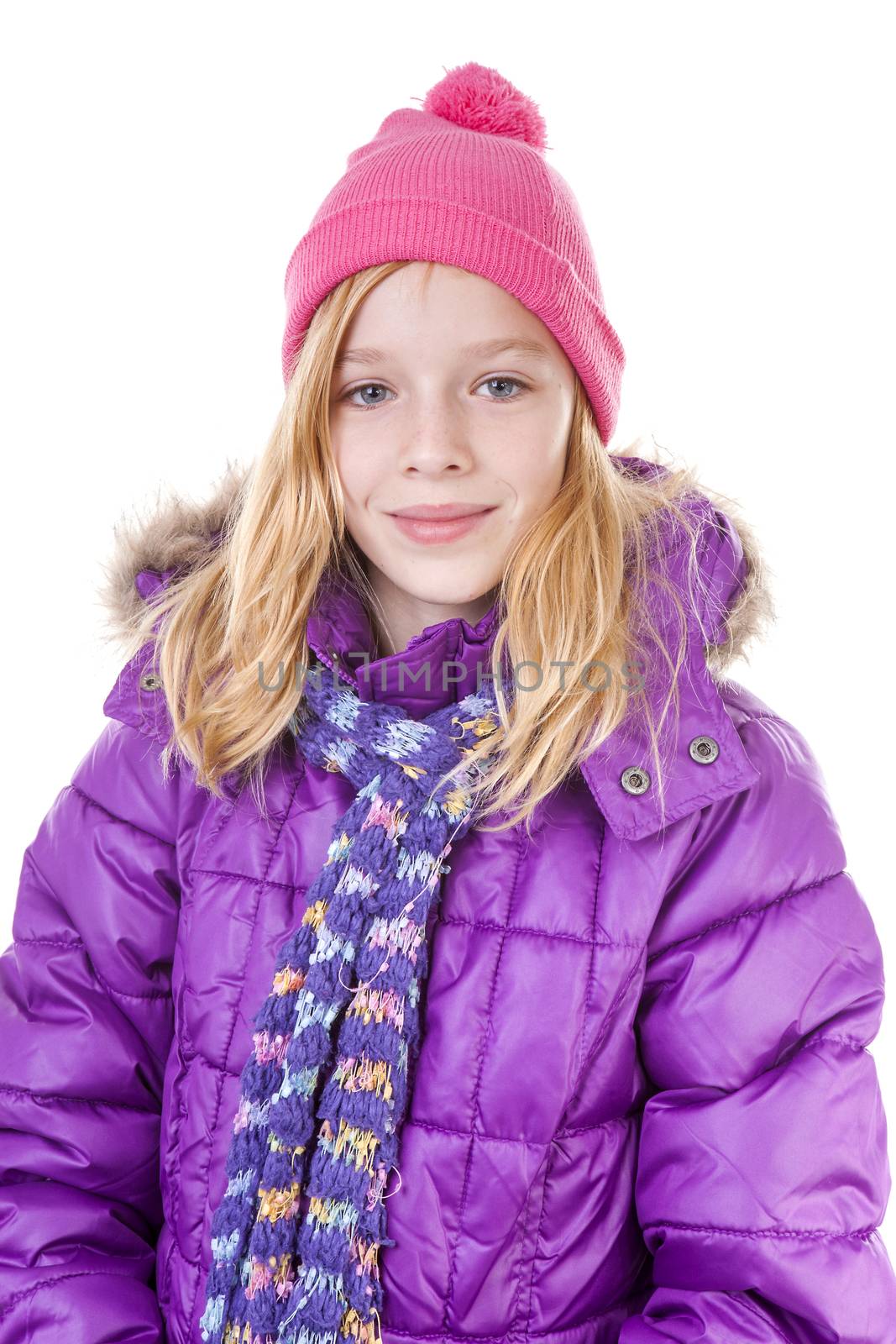 Teenage girl is posing in winter outfit over white backgroung