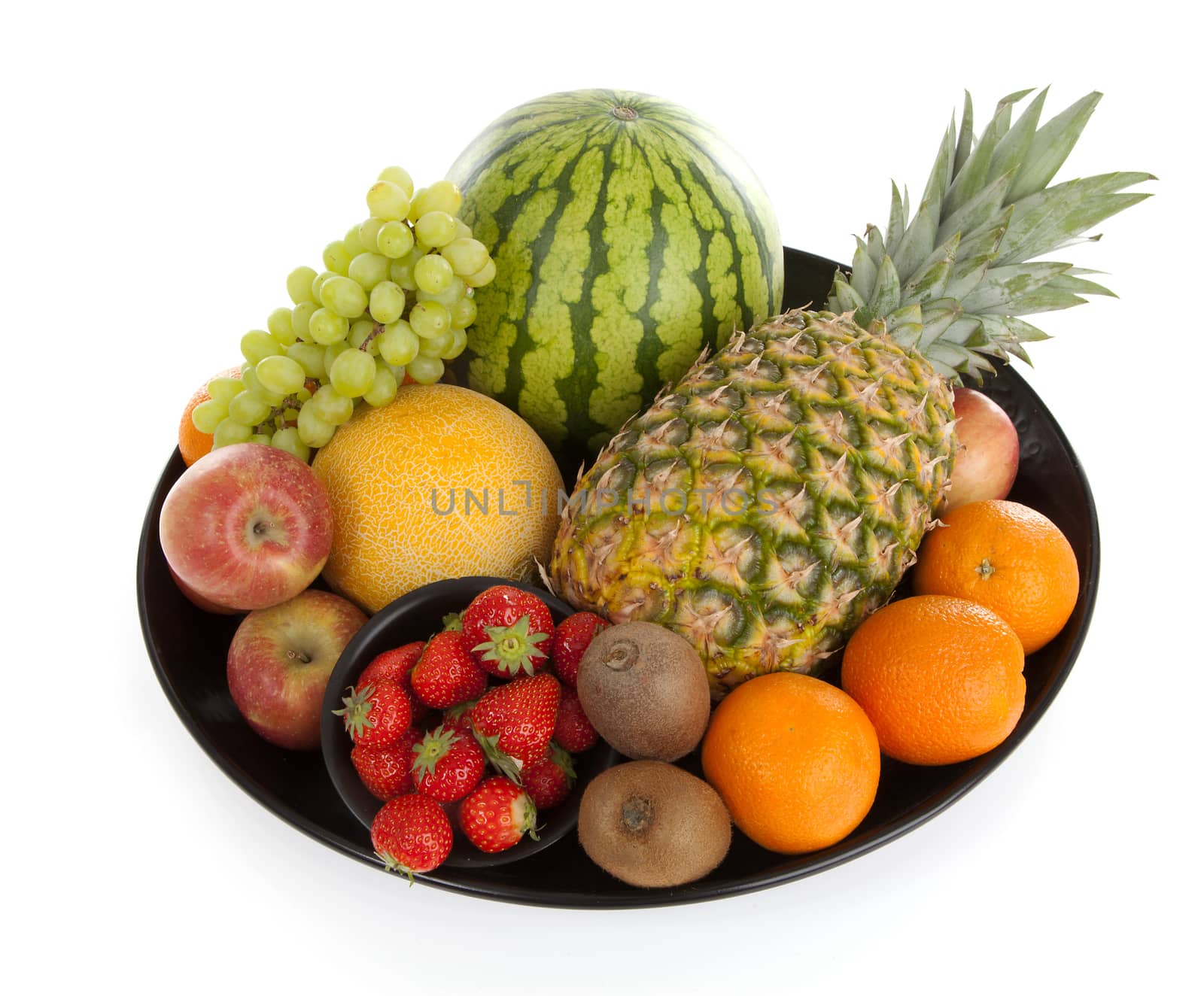 Big plate with lots of healthy fruits over white background