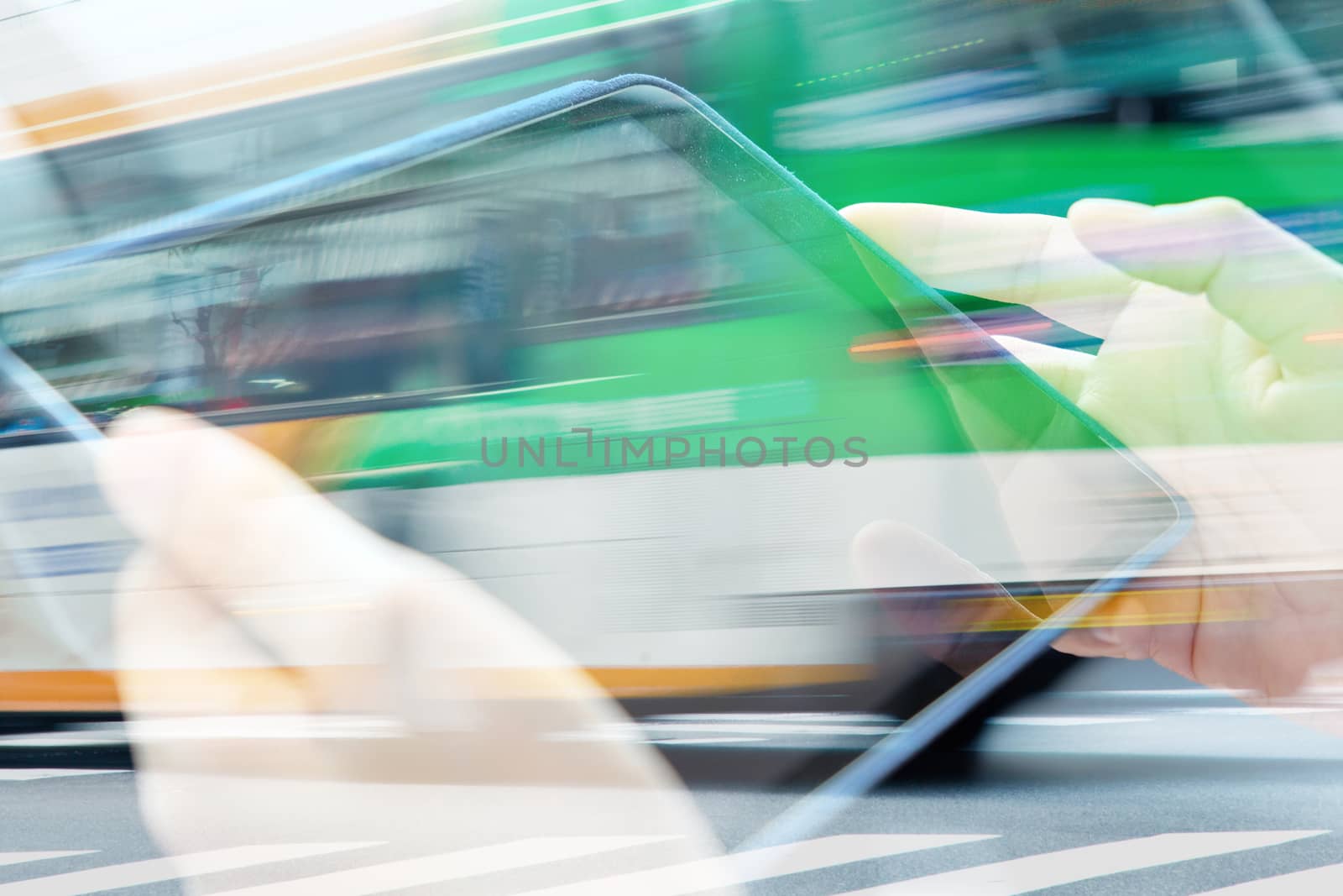 businesswomen Using digital tablet double exposure and blurred view of car on city street