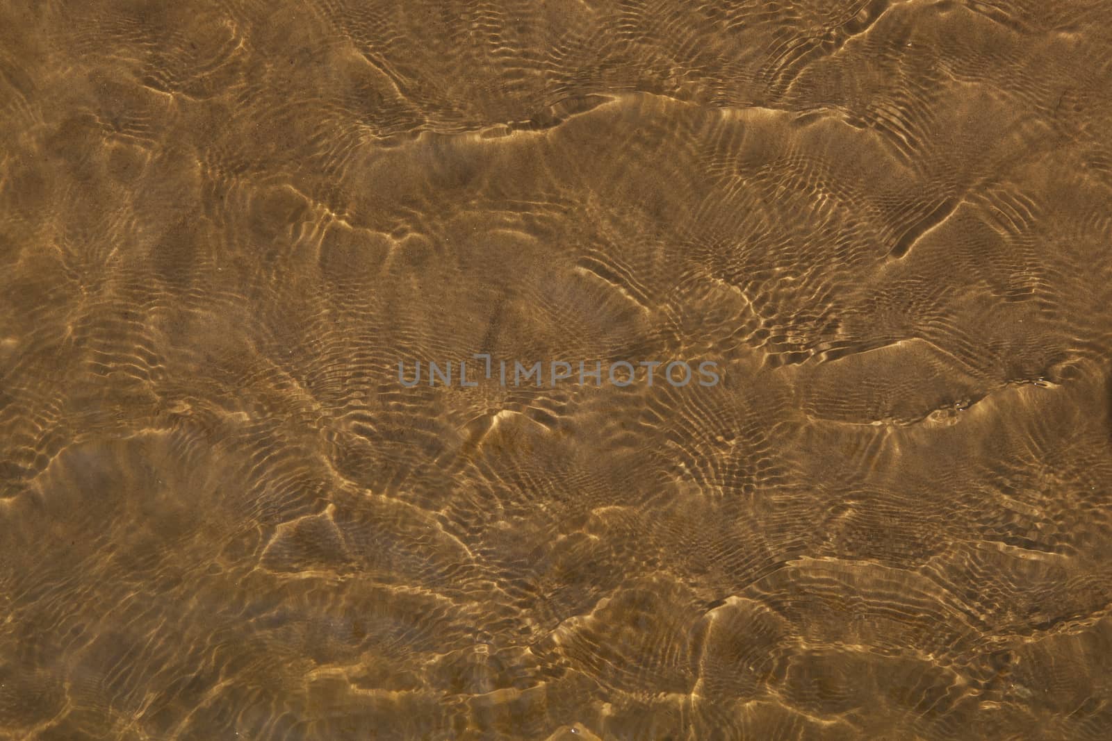 Reflections of water on the river Oka, on the sandy beach.