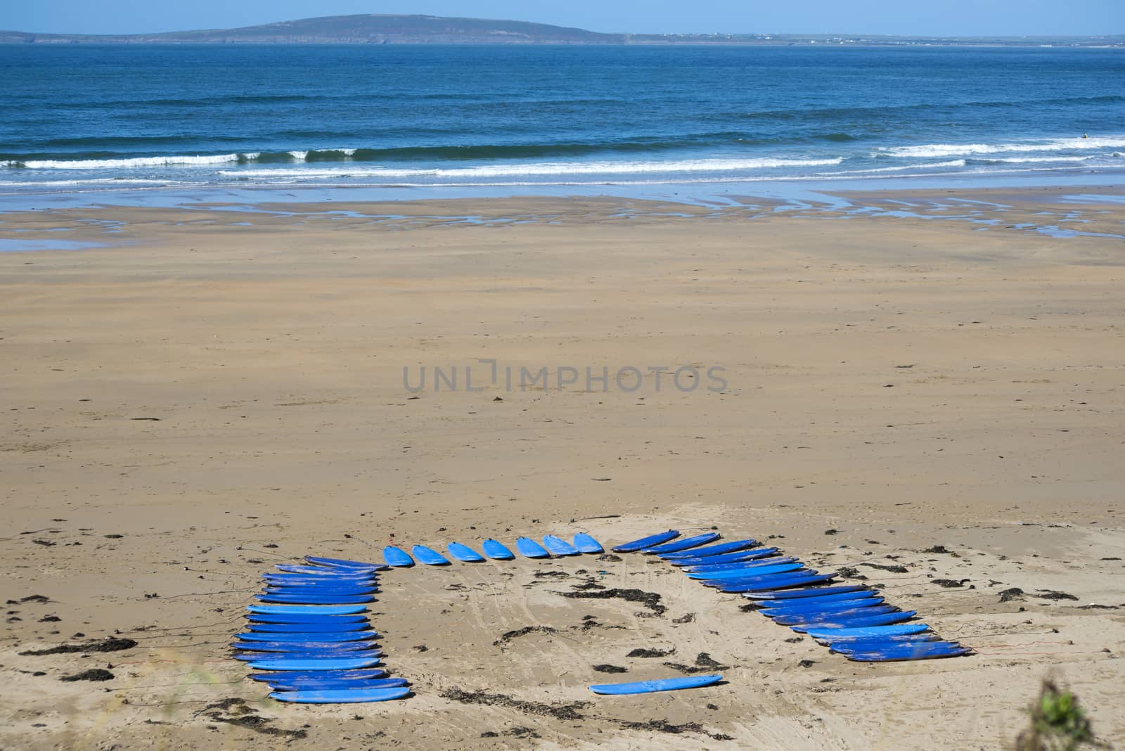 surf boards on the beach in ballybunion ready for a surf schools lessons