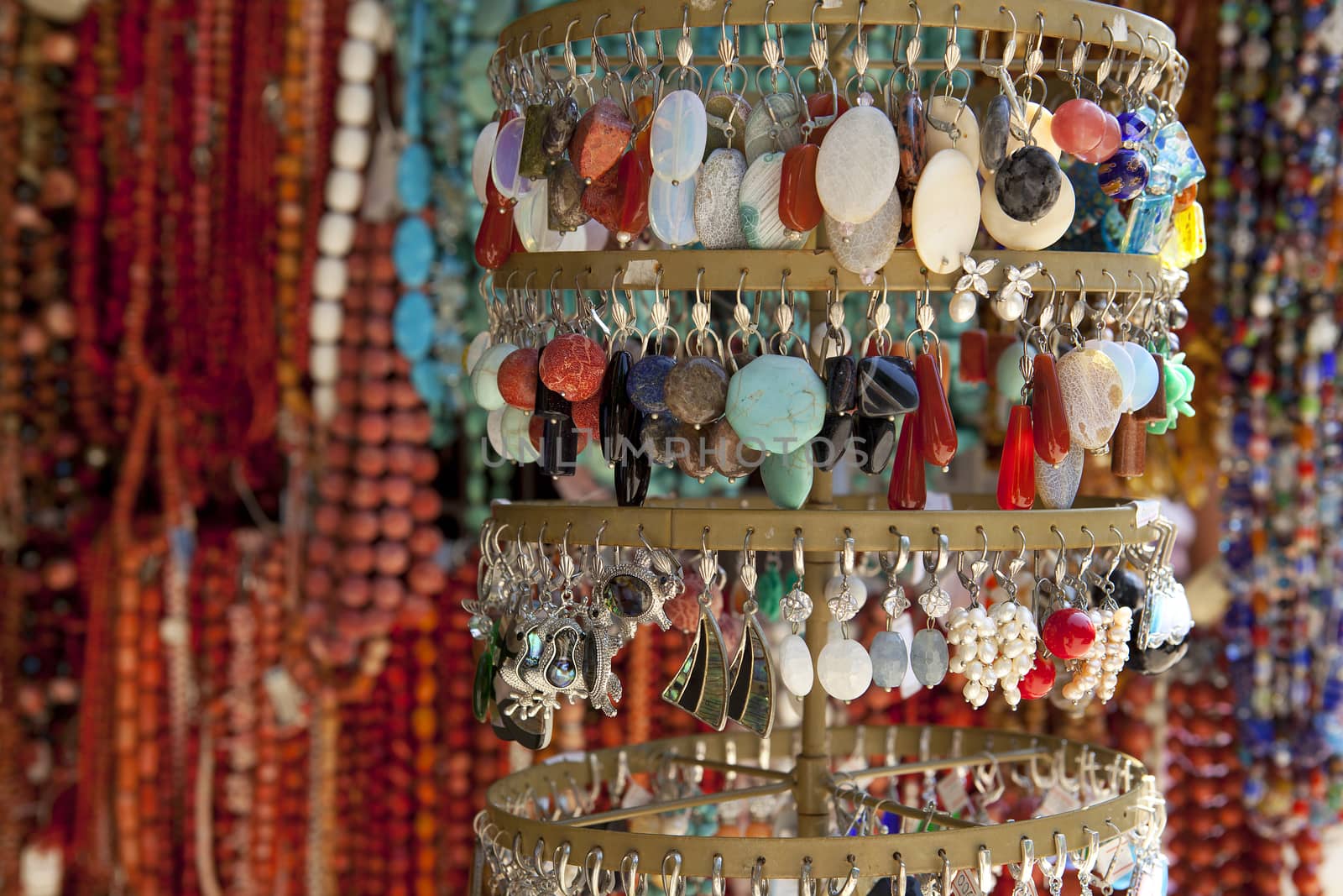A large number of beads of different colors and shapes for sale.