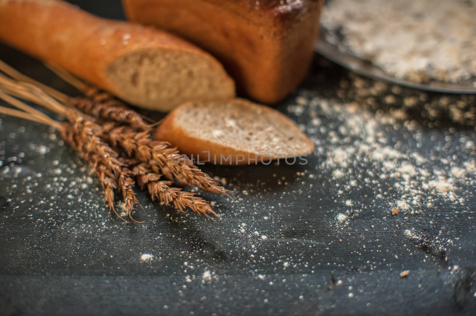 Bread composition with wheats. Very shallow DOF photo and specific art curly bokeh for extra volume.