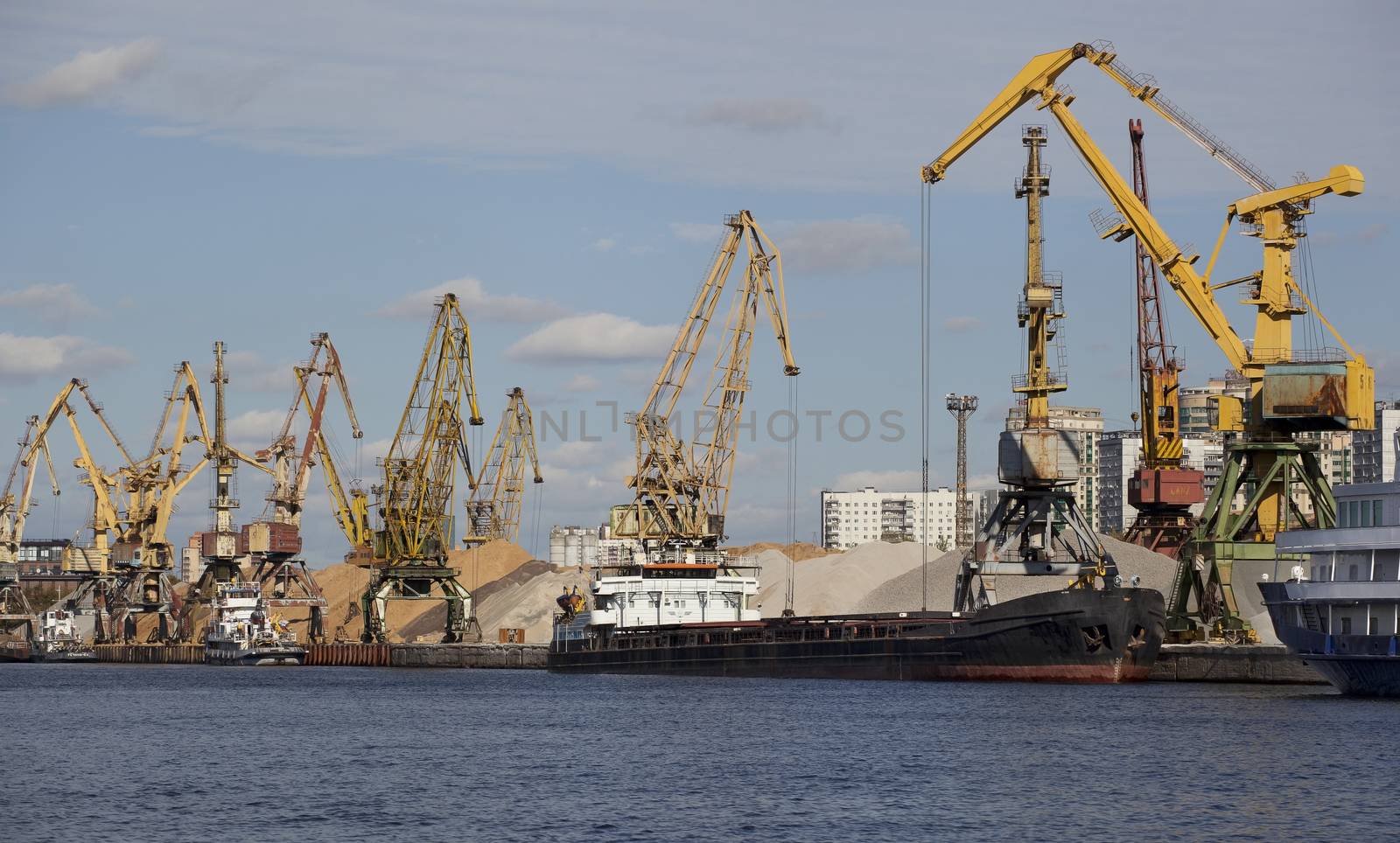 Cranes in the port for loading construction materials.