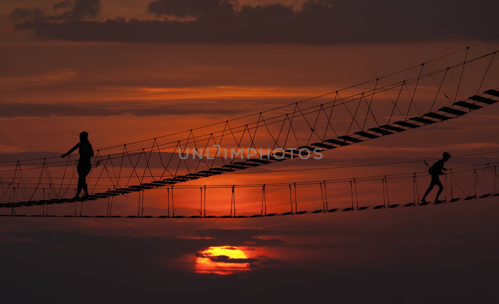 Suspension bridge over the ropes of the sunset.