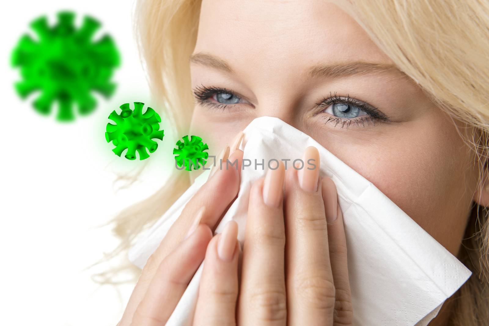 Portrait of a ill blond woman who is sneezing virus in a tissue