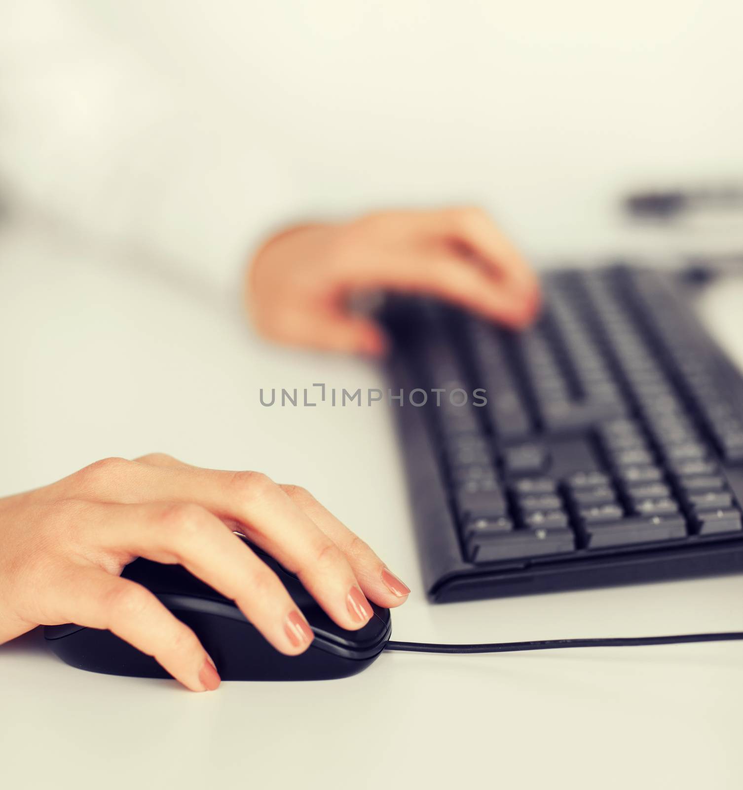 woman hands with keyboard and mouse by dolgachov