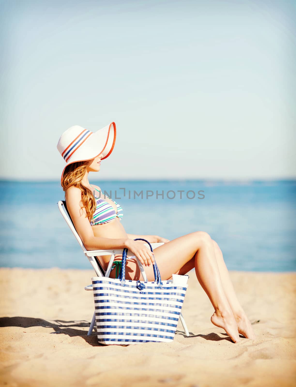 summer holidays and vacation - girl sunbathing on the beach chair