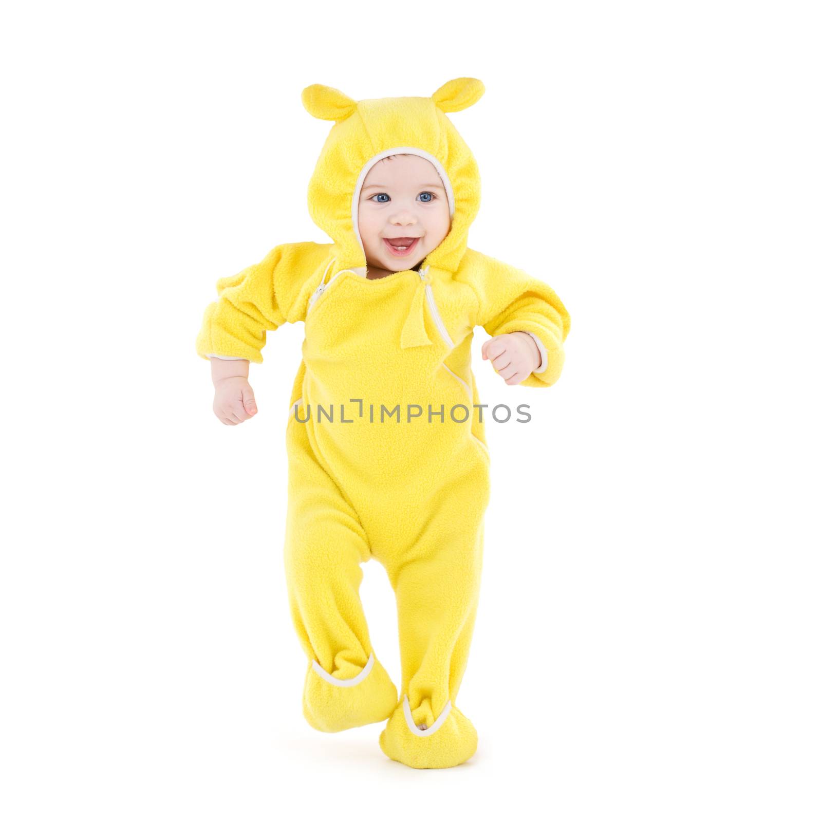 people, children, achievement and happiness concept - happy baby in yellow suit making first steps