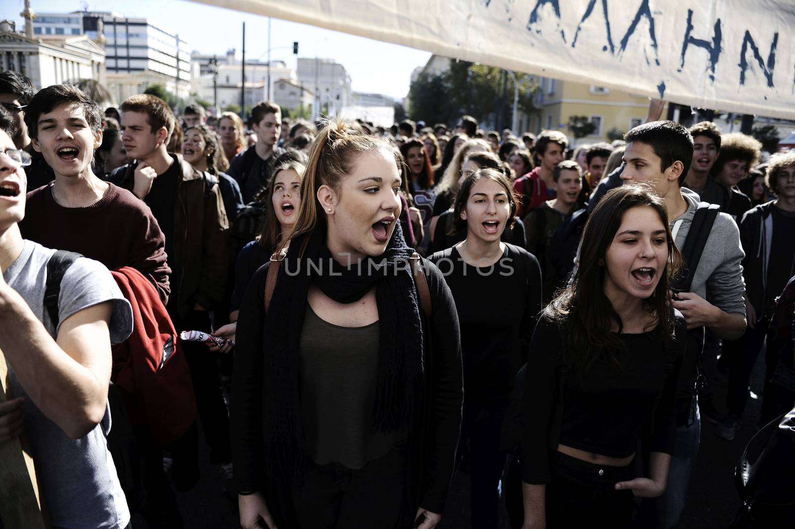GREECE, Athens: Thousands of student-protesters fill the streets of Athens, Greece on November 2, 2015. The young demonstrators yell chants and carry signs as they rally against cuts to education and a shortage of teachers, amid ongoing protests against austerity in Greece. Reports from local media indicate that a contingent had broken off from the larger protest, vandalizing a cell phone store, and trying to damage a bank on Othonos, a street in Athens.