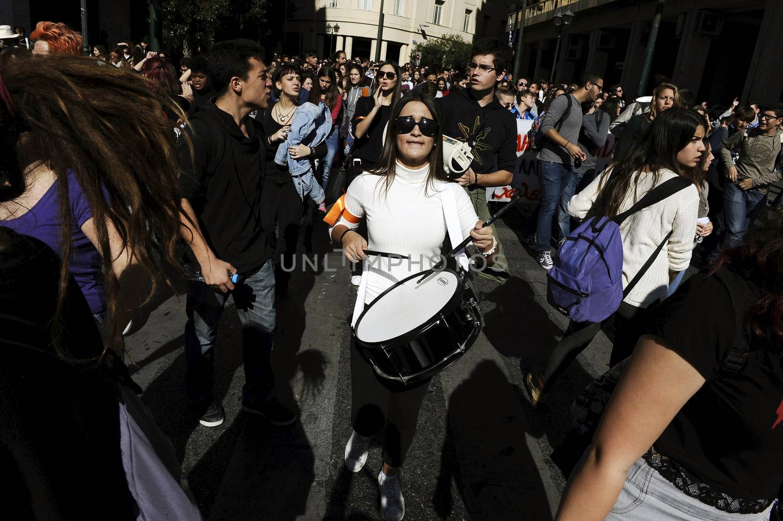 GREECE, Athens: Thousands of student-protesters fill the streets of Athens, Greece on November 2, 2015. The young demonstrators yell chants and carry signs as they rally against cuts to education and a shortage of teachers, amid ongoing protests against austerity in Greece. Reports from local media indicate that a contingent had broken off from the larger protest, vandalizing a cell phone store, and trying to damage a bank on Othonos, a street in Athens.