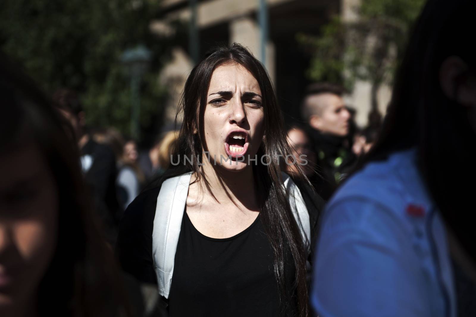 GREECE, Athens: A woman yells as thousands of student-protesters fill the streets of Athens, Greece on November 2, 2015. The young demonstrators yell chants and carry signs as they rally against cuts to education and a shortage of teachers, amid ongoing protests against austerity in Greece. Reports from local media indicate that a contingent had broken off from the larger protest, vandalizing a cell phone store, and trying to damage a bank on Othonos, a street in Athens.