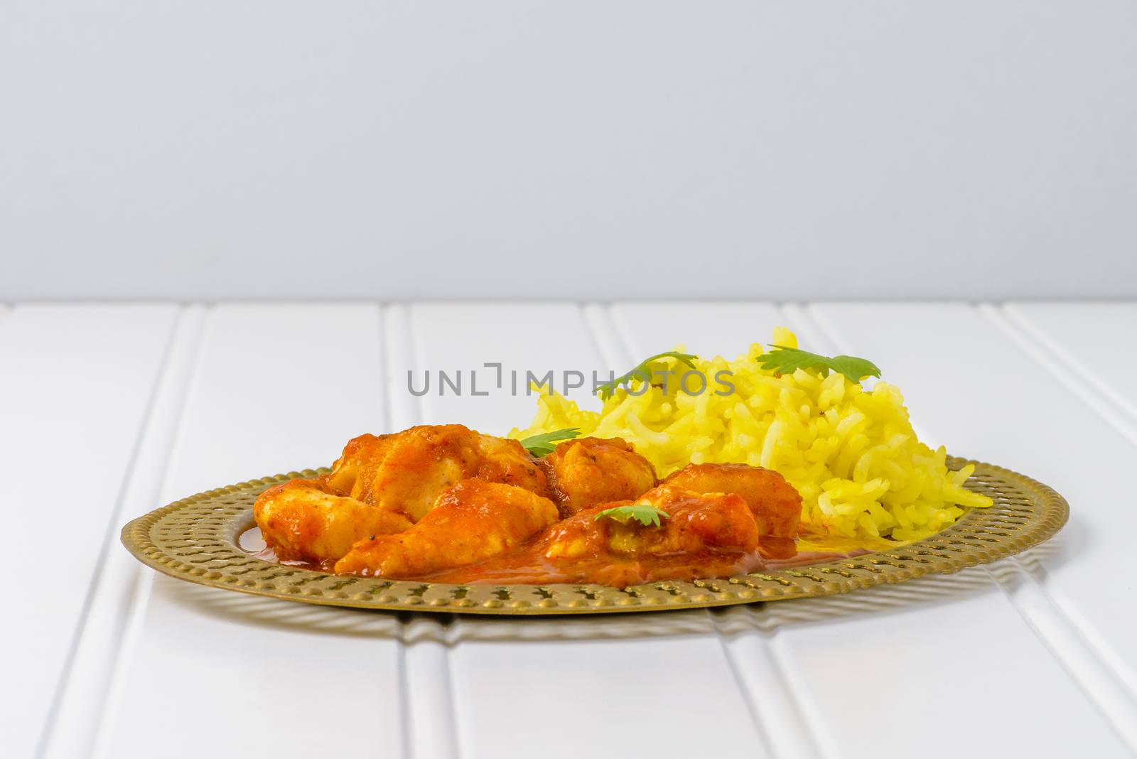 Plate of chicken vindaloo served with basmati rice.