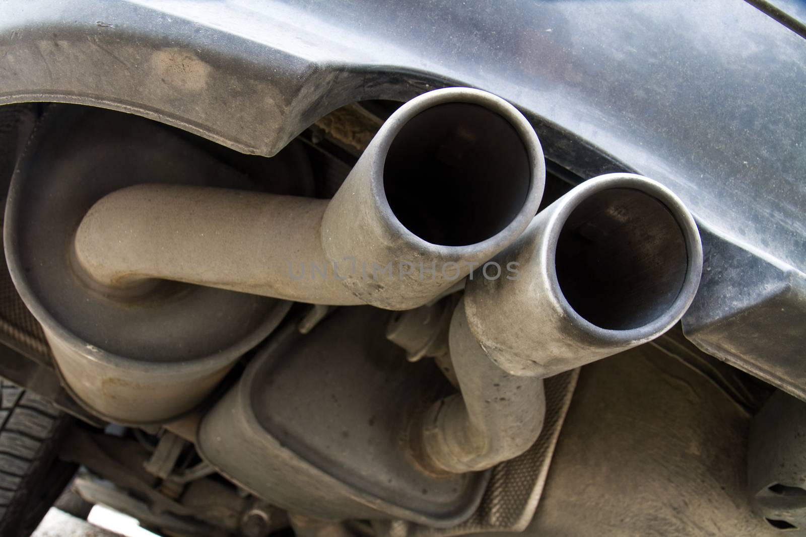 dirty tailpipes from a well used car
