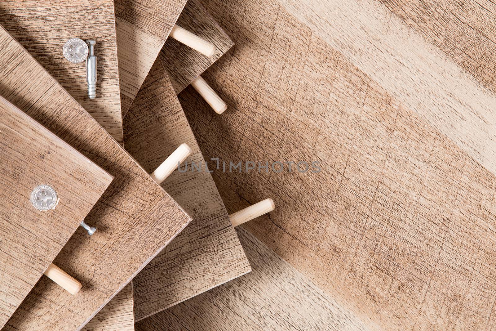 High Angle Close Up of Unfinished Wood Planks with Pegs and Holes - Background of Unassembled Wooden Shelves with Copy Space