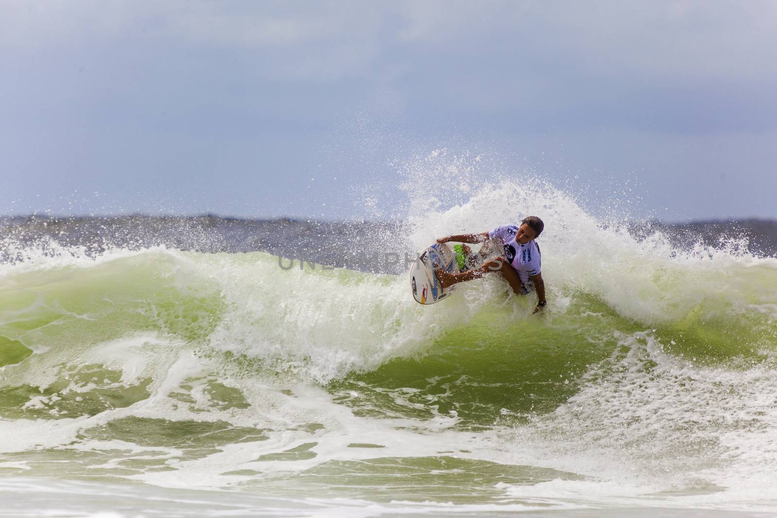 SNAPPER ROCKS, GOLD COAST, AUSTRALIA - 9 MARCH: Unidentified Surfer races the Quiksilver & Roxy Pro World Title Event. 9 March 2013, Snapper Rocks, Gold Coast, Australia