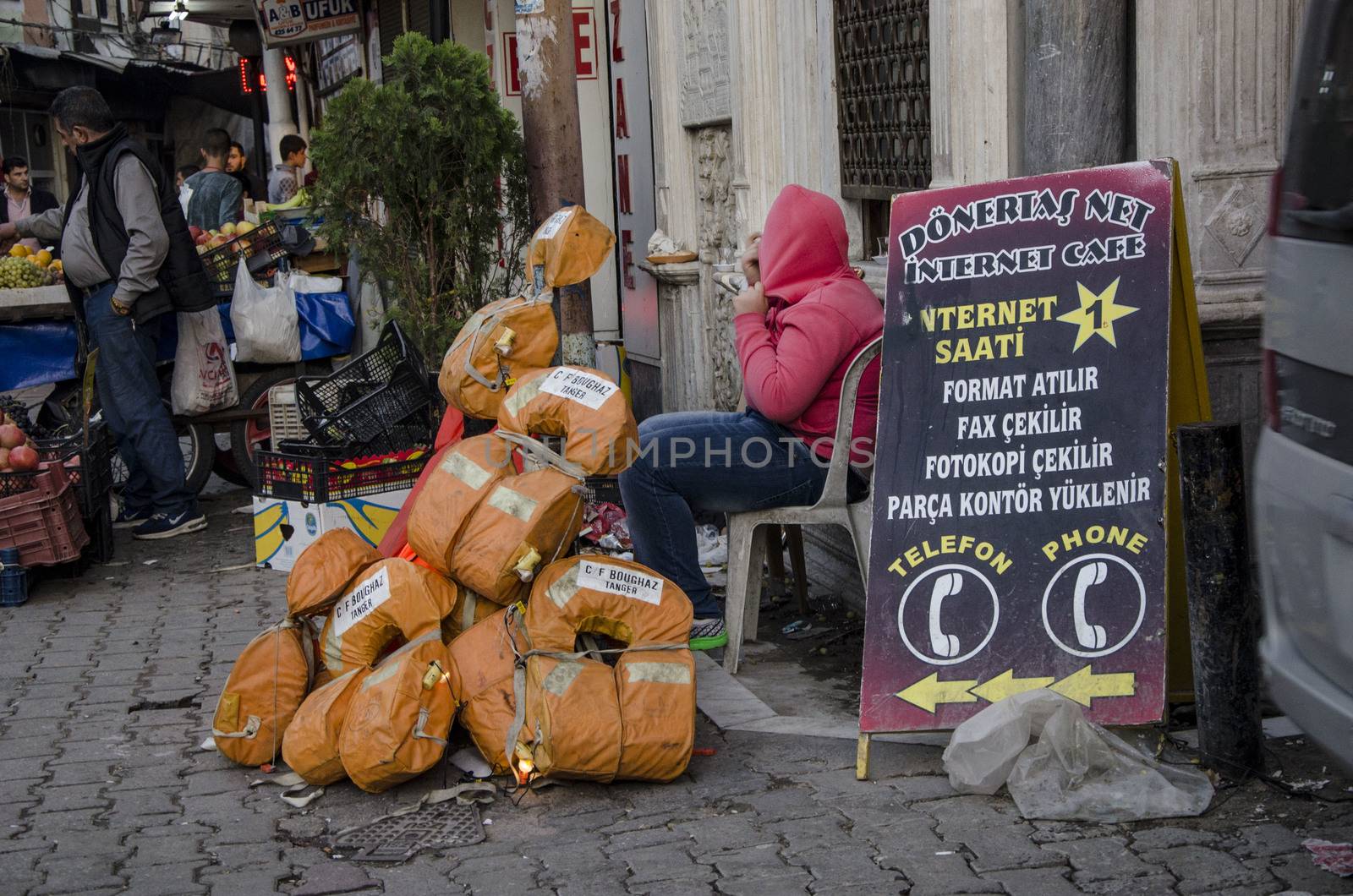 TURKEY, Izmir: A family of migrants beg on a street of Basmane, a poor district of Izmir, western Turkey, on October 25, 2015. There, Syrian refugees live in rotten buildings and cheap hotels, counting their days to leave Turkey for Greece or another European country. Everywhere on the streets of Basmane, passerby can spot banners and board signs written in Arabic, from money exchange, cafes, hotels, jewelry to life jackets for sale. It is estimated that there are currently over 74,000 registered Syrians in Izmir, but the number of unregistered refugees claims much higher, bringing the total well over 100,000 people. A survey conducted by the Association for Solidarity with Asylum Seekers and Migrants (ASAM) in Turkey showed that 45 percent among these are minors, the majority are without work or stable places to reside.