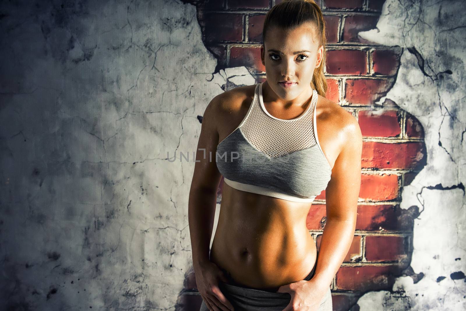 Female fitness model posing in studio. Cinematic Portrait Style.