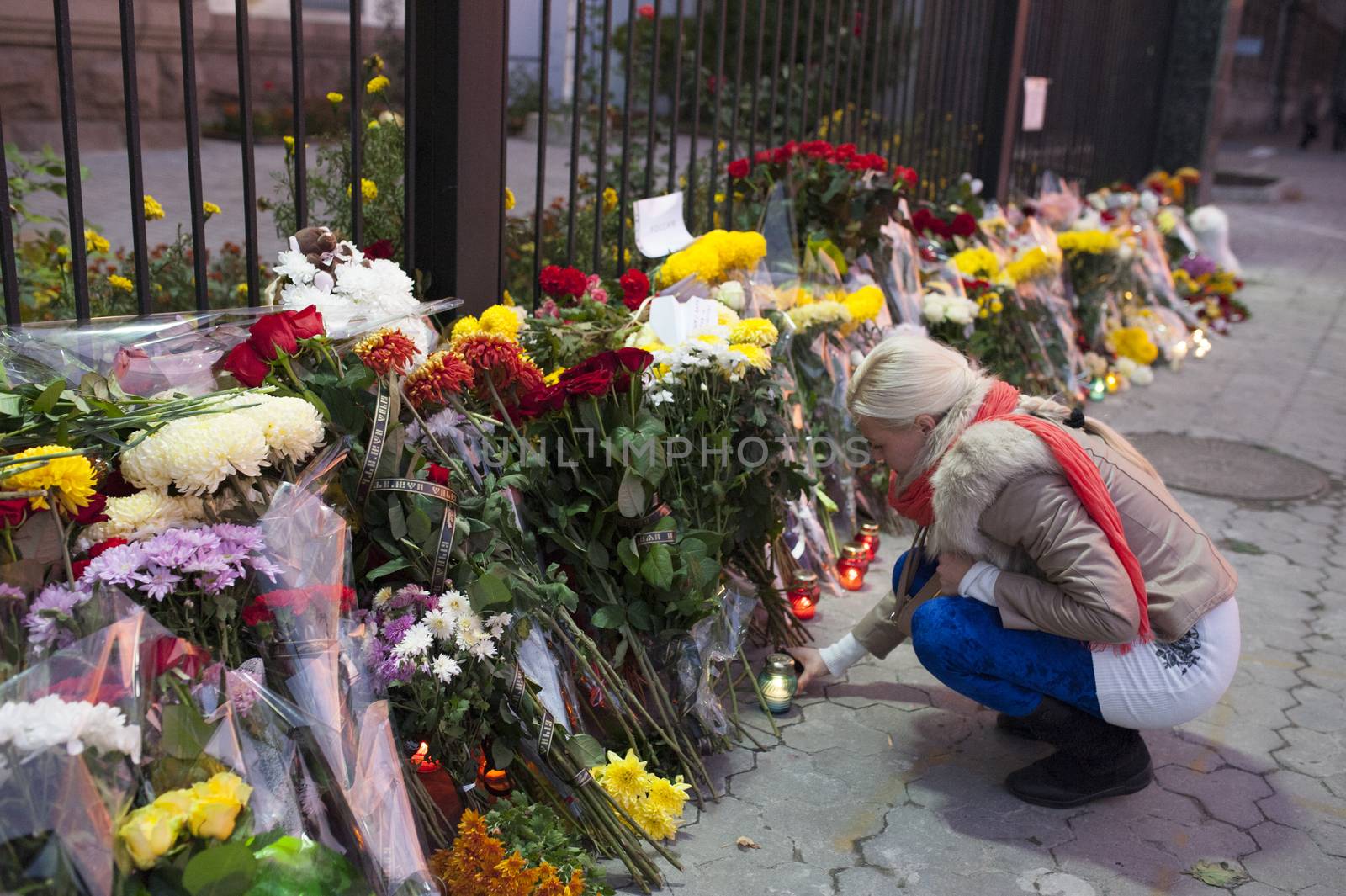 UKRAINE, Kiev: A woman lights a candle outside the Russian embassy in Kiev, Ukraine, in tribute to the victims of crashed Russian Metrojet plane in Egypt, on November 1, 2015. The Airbus, with 224 people on board, crashed in a mountainous part of Egypt's Sinai Peninsula on October 31, 2015
