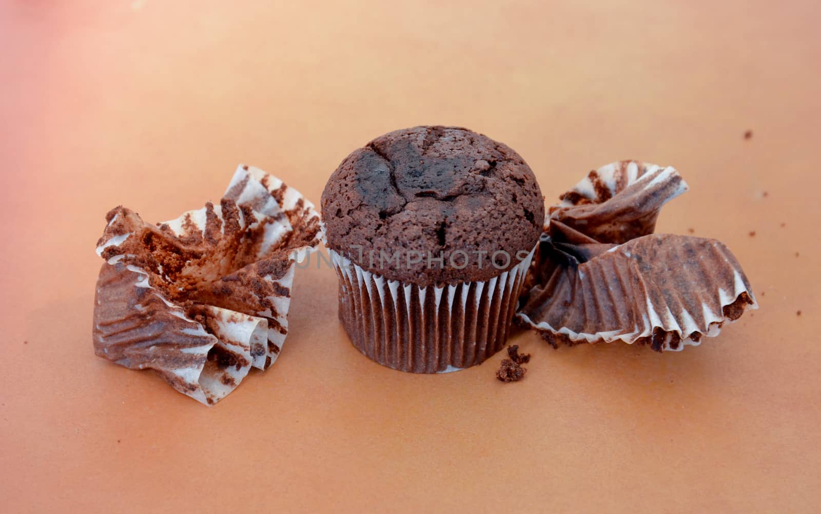 picture of a chocolate muffin on wood background