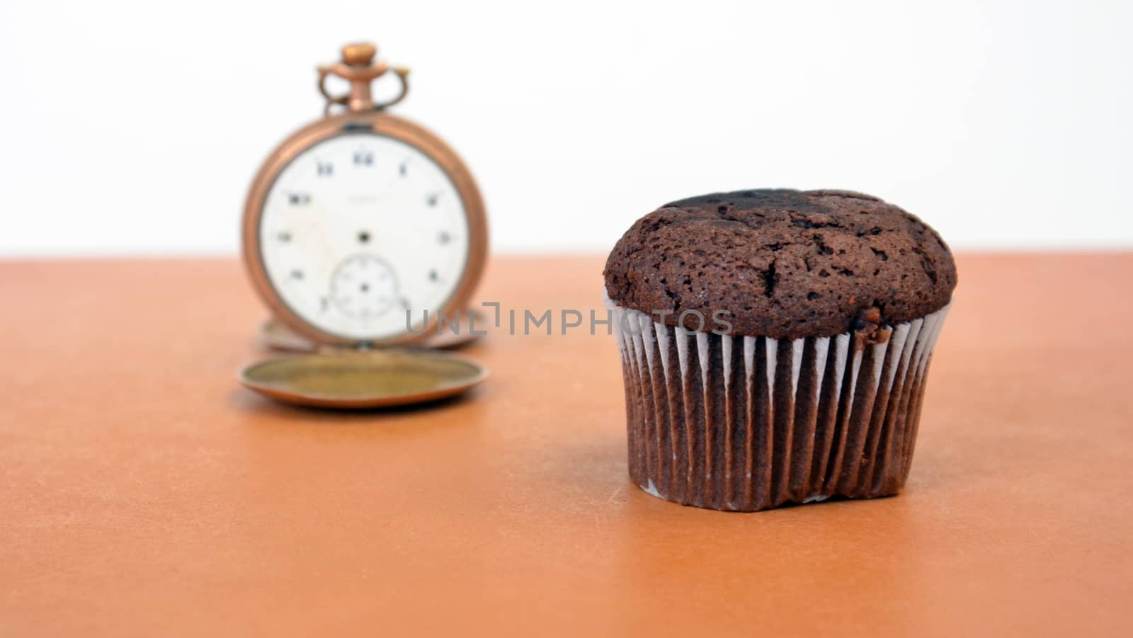 picture of a chocolate muffin on wood background