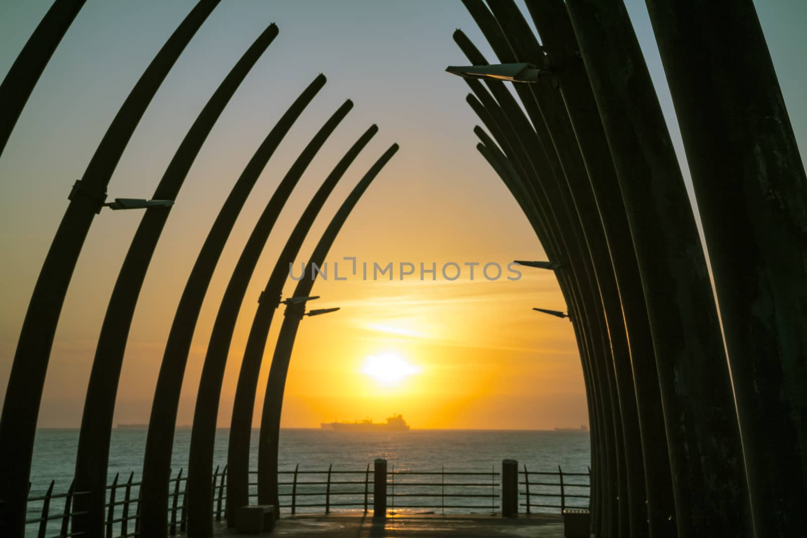 Umhlanga Pier in Durban South Africa in the morning Sunrise over the Indian Ocean with ships on the horizon
