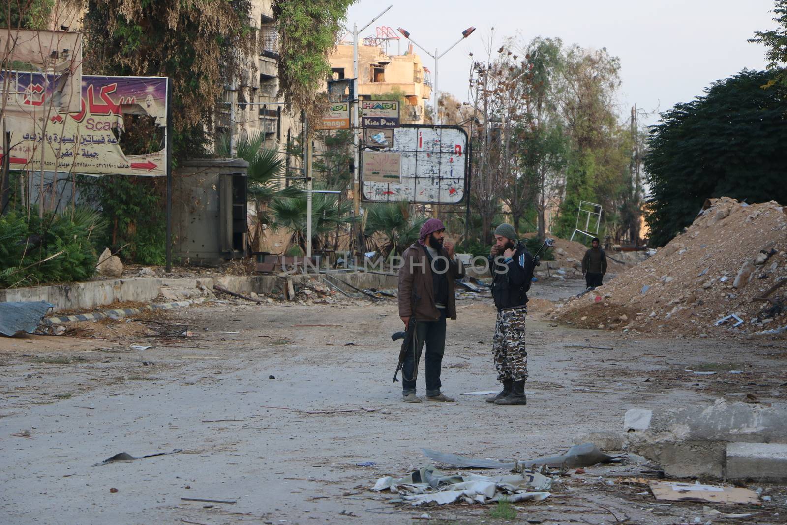 SYRIA, Harasta : Two rebels have a conversation while clashes between several rebel factions, Syrian army and its allies intensify in Harasta, in the northern suburb of the Syrian capital Damascus, on November 2, 2015. Violence in Damascus suburbs where rebels have been entrenched for years has claimed the lives of thousands of civilians.