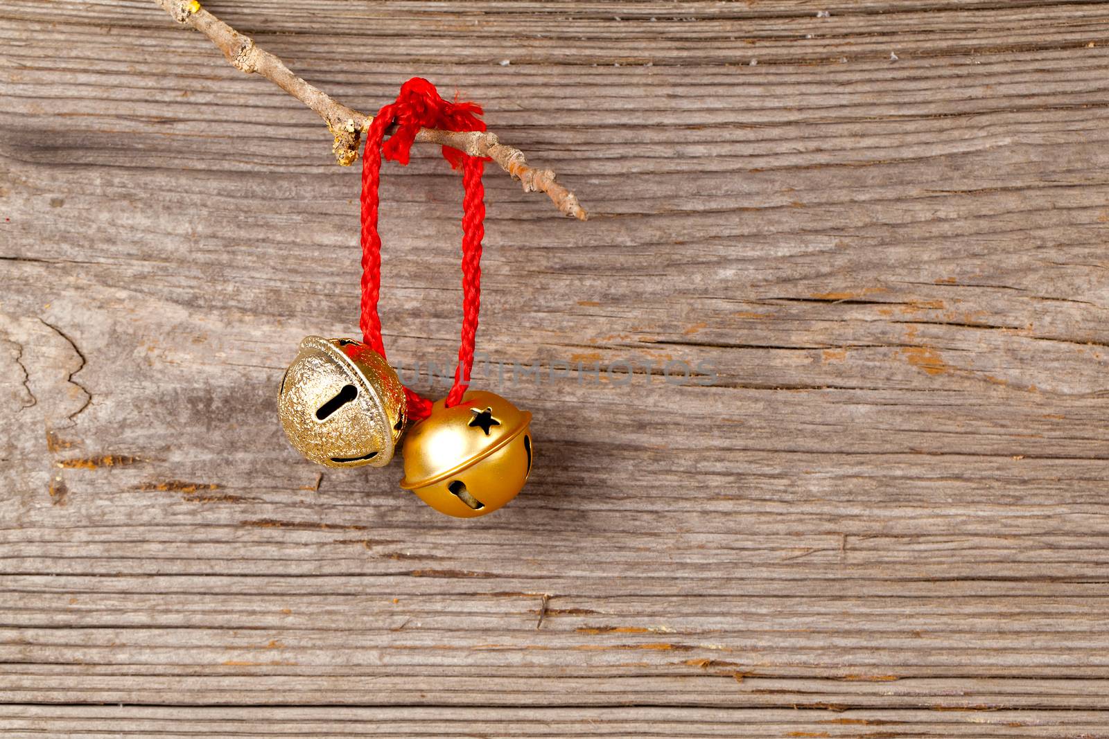 Christmas bells on wooden background by motorolka