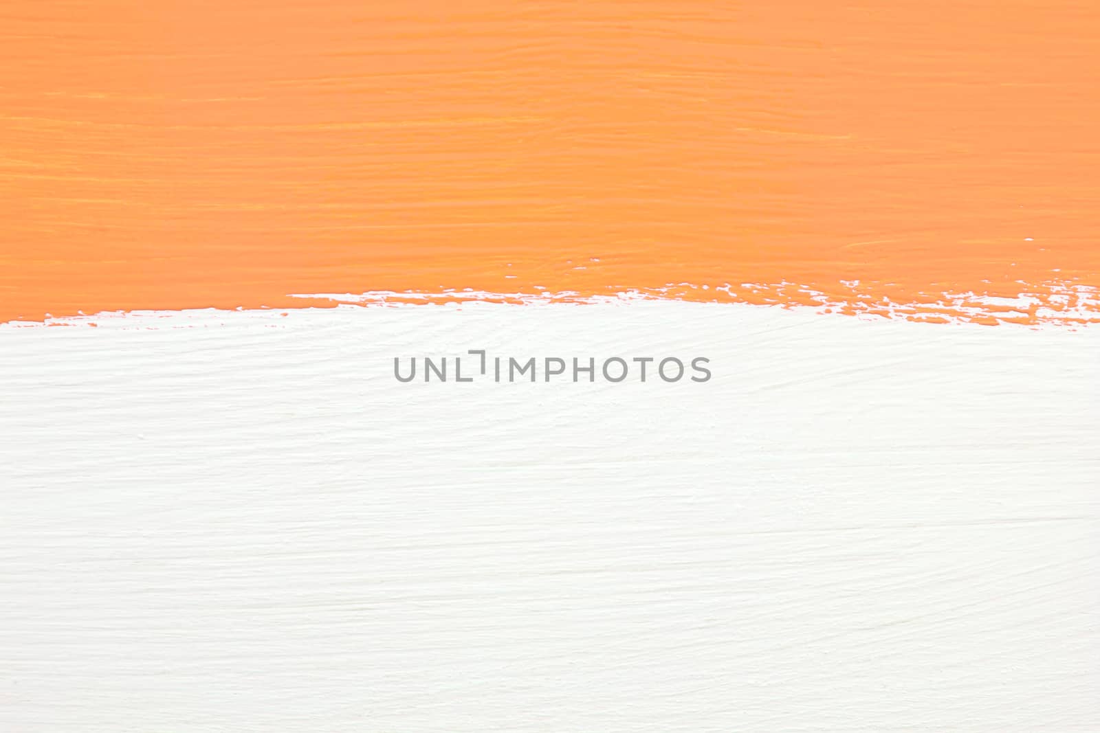 Horizontal stripe of orange paint over white painted wooden background