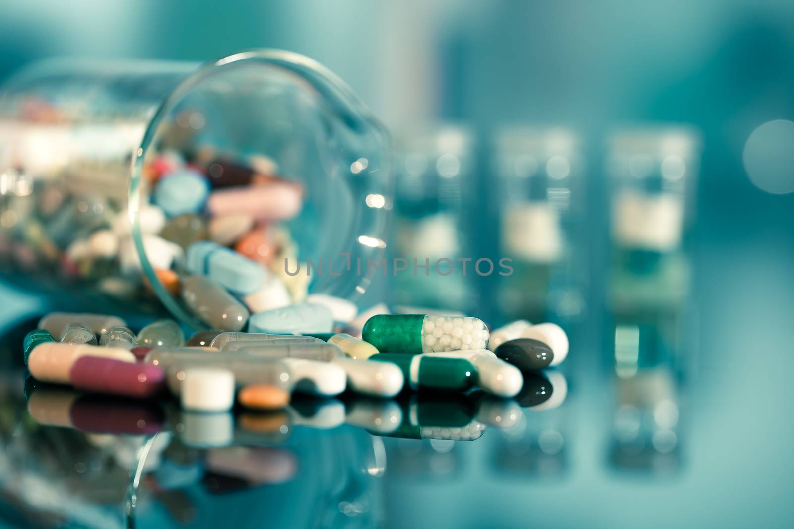 Colorful tablets with capsules and pills on blue background