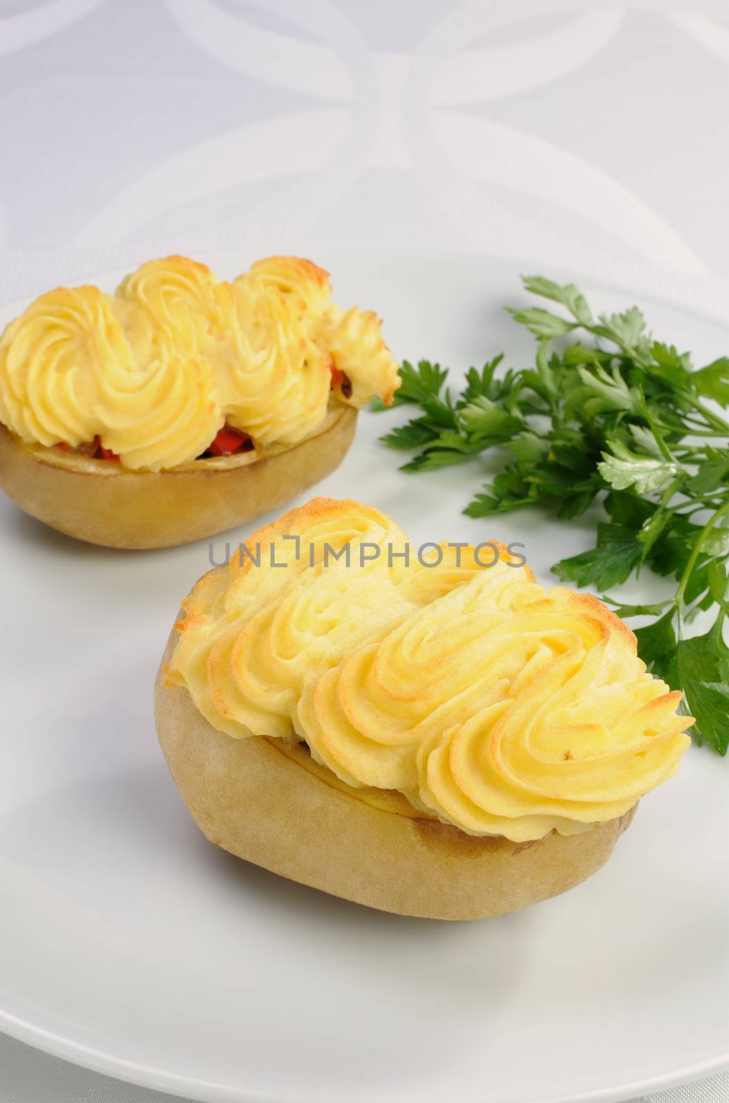 Baked potatoes stuffed with vegetables on a platter