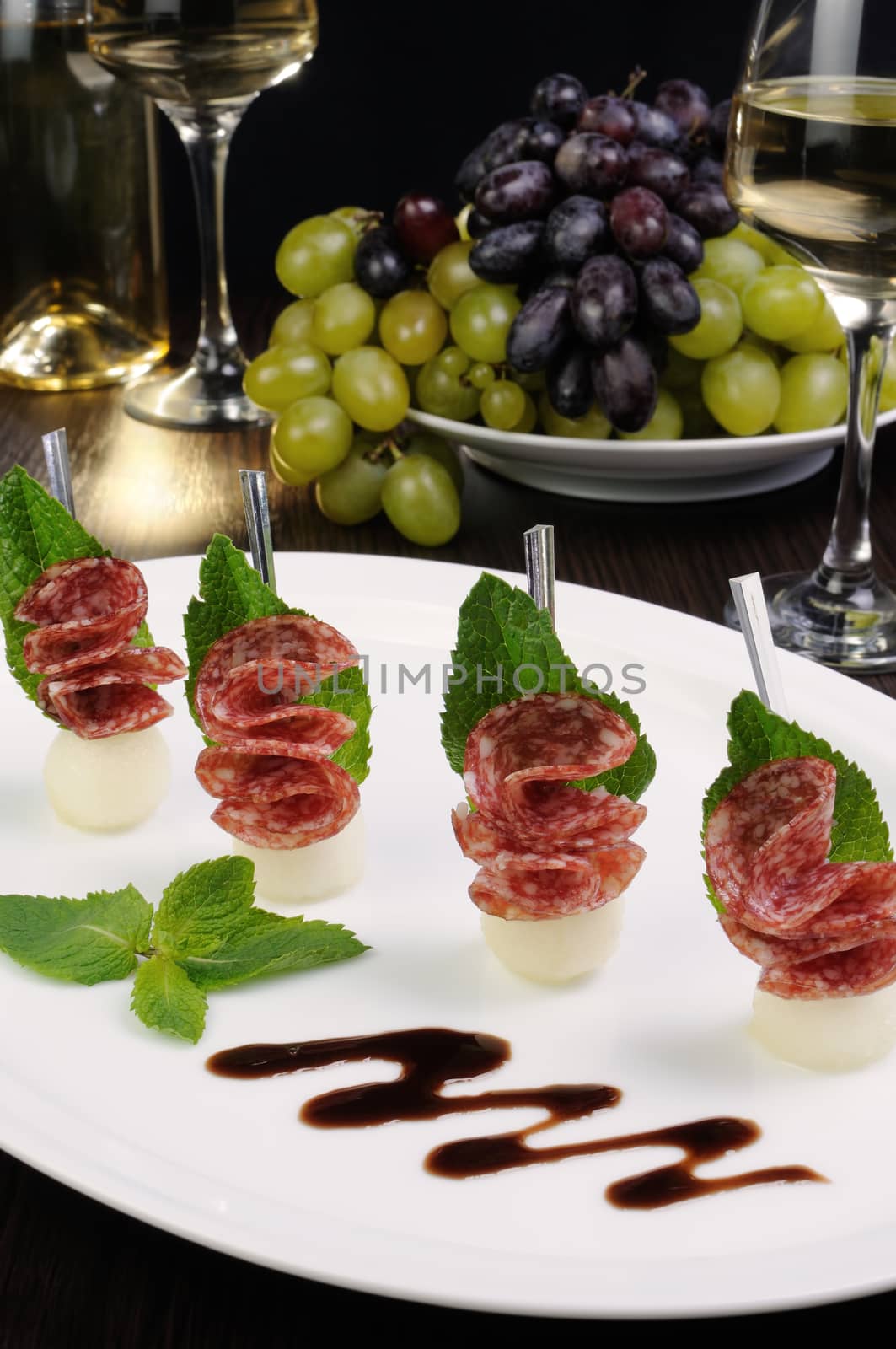 Canape of balls with a melon and salami by Apolonia