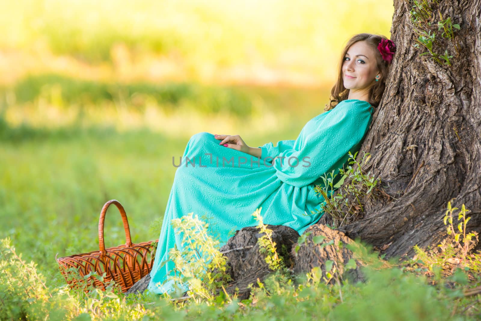 The young beautiful girl walks through the forest on a warm summer day