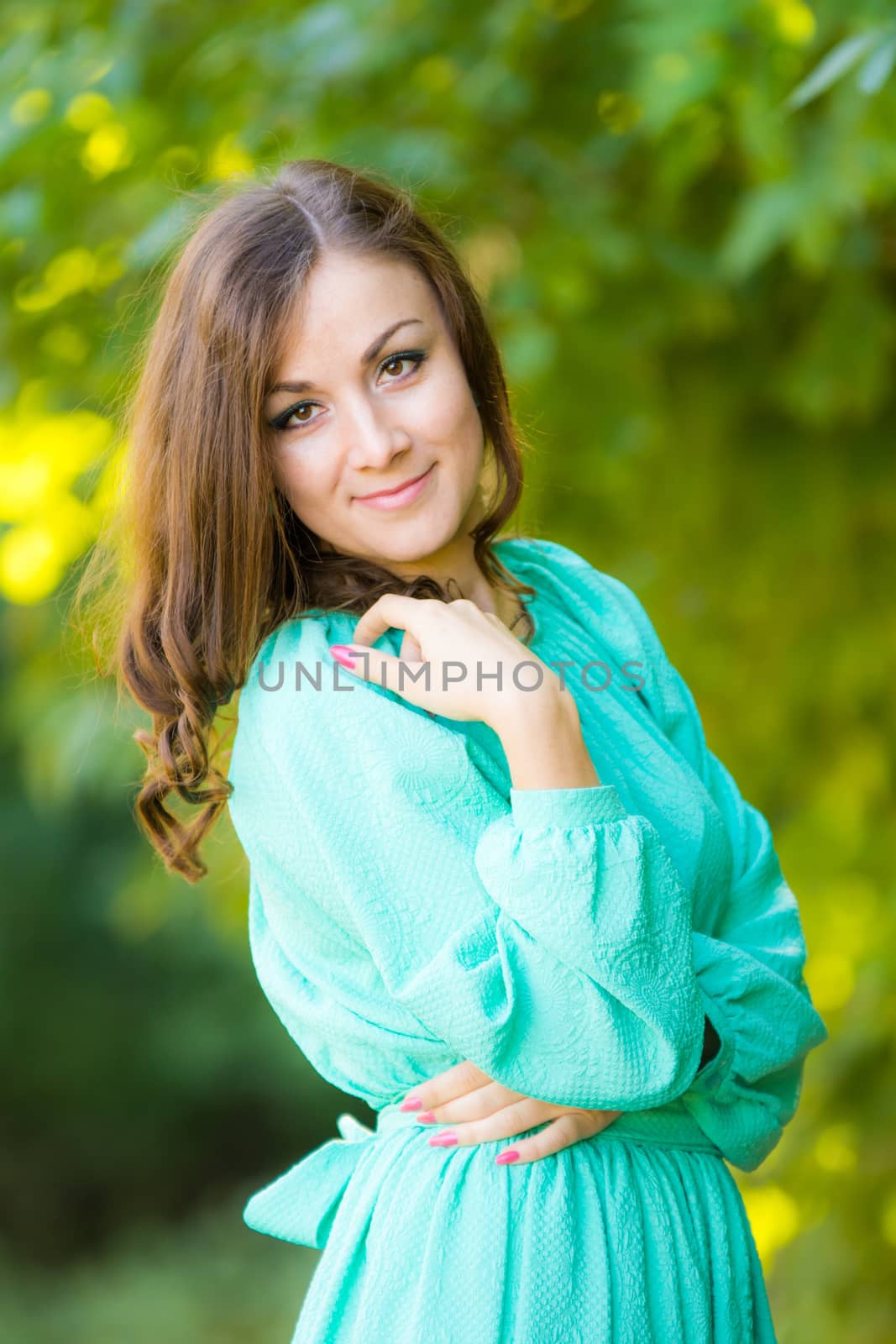 The young beautiful girl walks through the forest on a warm summer day