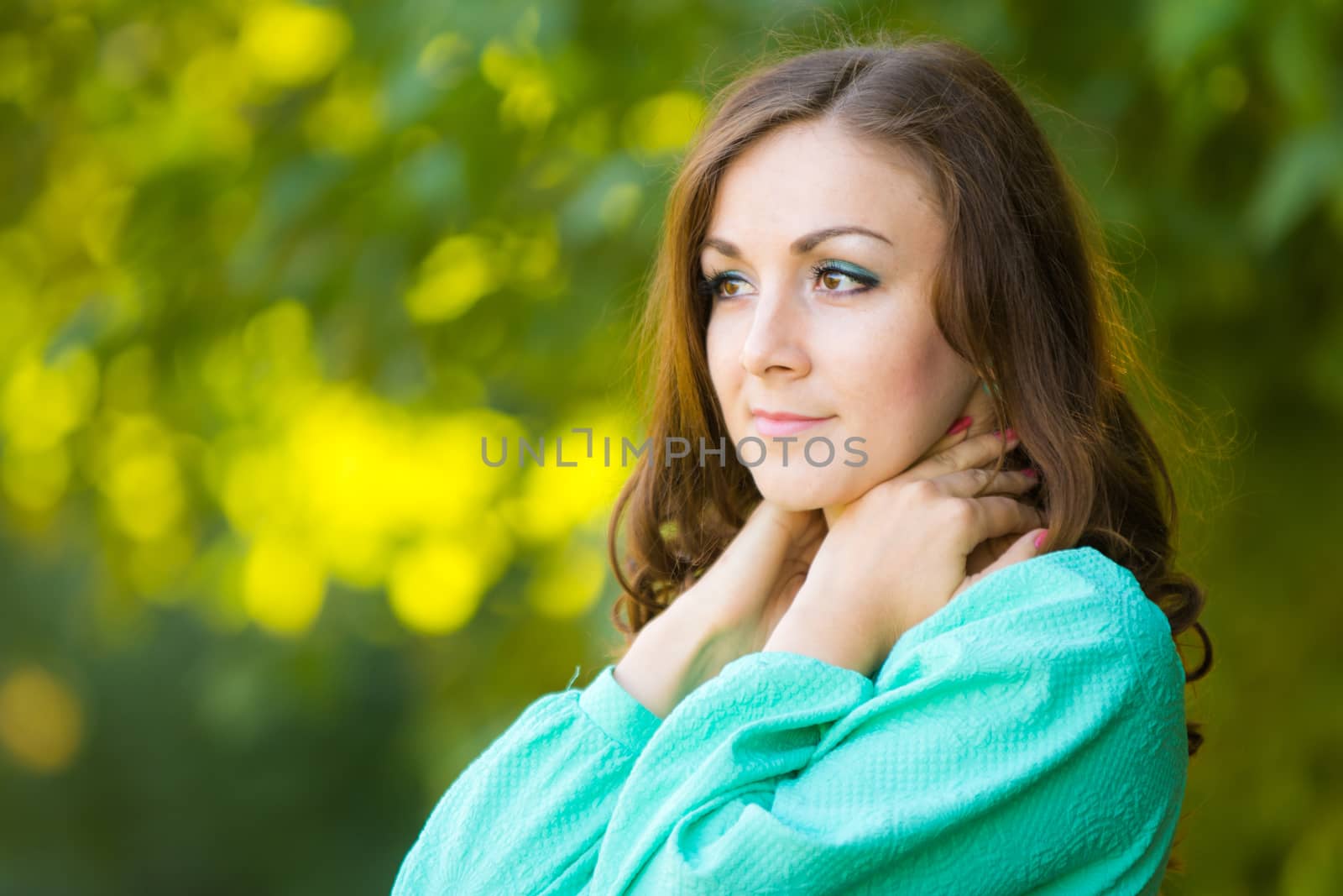 The young beautiful girl walks through the forest on a warm summer day