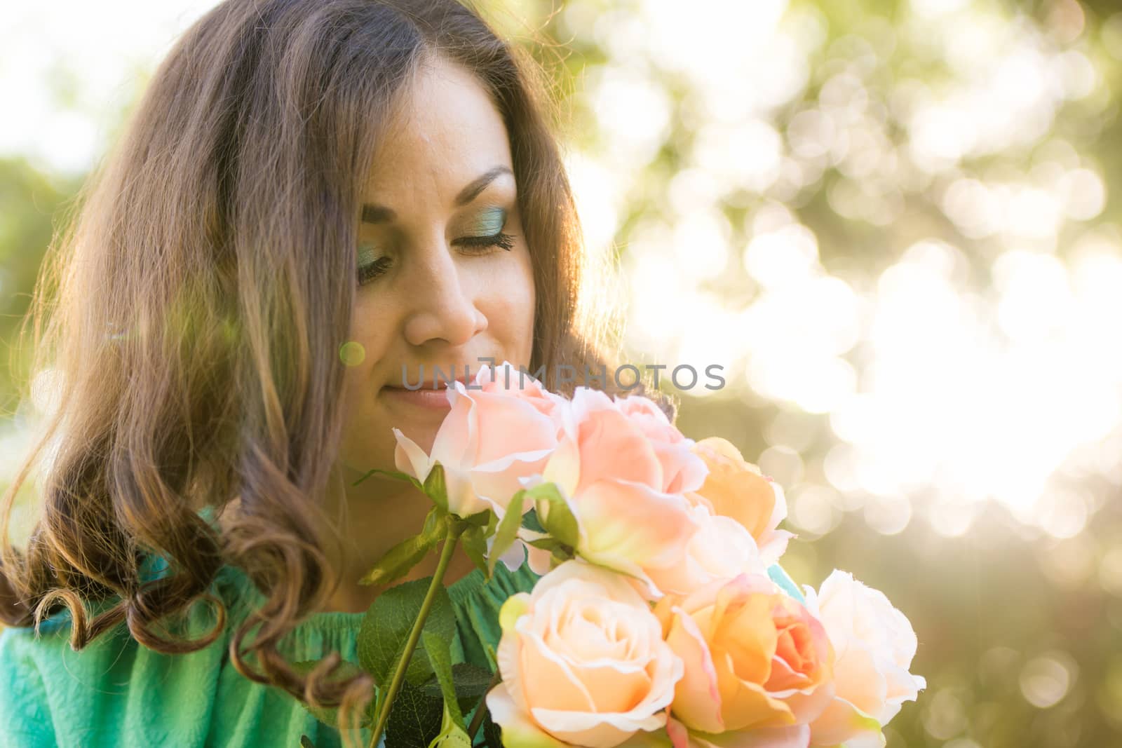 Young beautiful girl in a long dress walking in the woods on a warm summer day