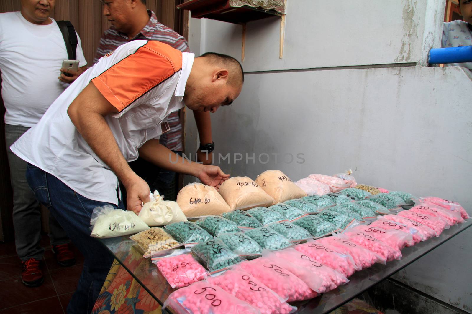 INDONESIA, Medan: Police detectives reveal at a conference that they have busted drug dealers from an international network in the city of Medan, Indonesia on November 3, 2015. A wide array of contraband are on display, reportedly including 12 kg of methamphetamine and 37,000 ecstasy pills, along with scales and weapons. The drugs on display are believed to be of Chinese origin, and the suspect is thought to have been operating in the area for at least six months.