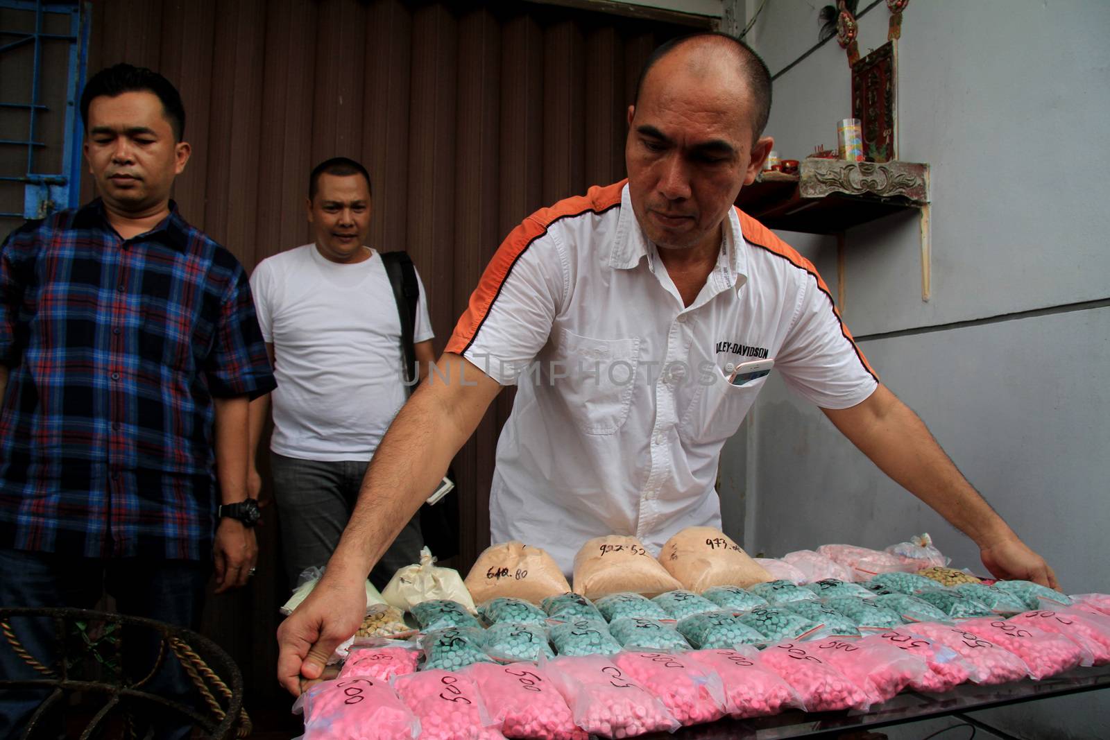INDONESIA, Medan: Police detectives reveal at a conference that they have busted drug dealers from an international network in the city of Medan, Indonesia on November 3, 2015. A wide array of contraband are on display, reportedly including 12 kg of methamphetamine and 37,000 ecstasy pills, along with scales and weapons. The drugs on display are believed to be of Chinese origin, and the suspect is thought to have been operating in the area for at least six months.