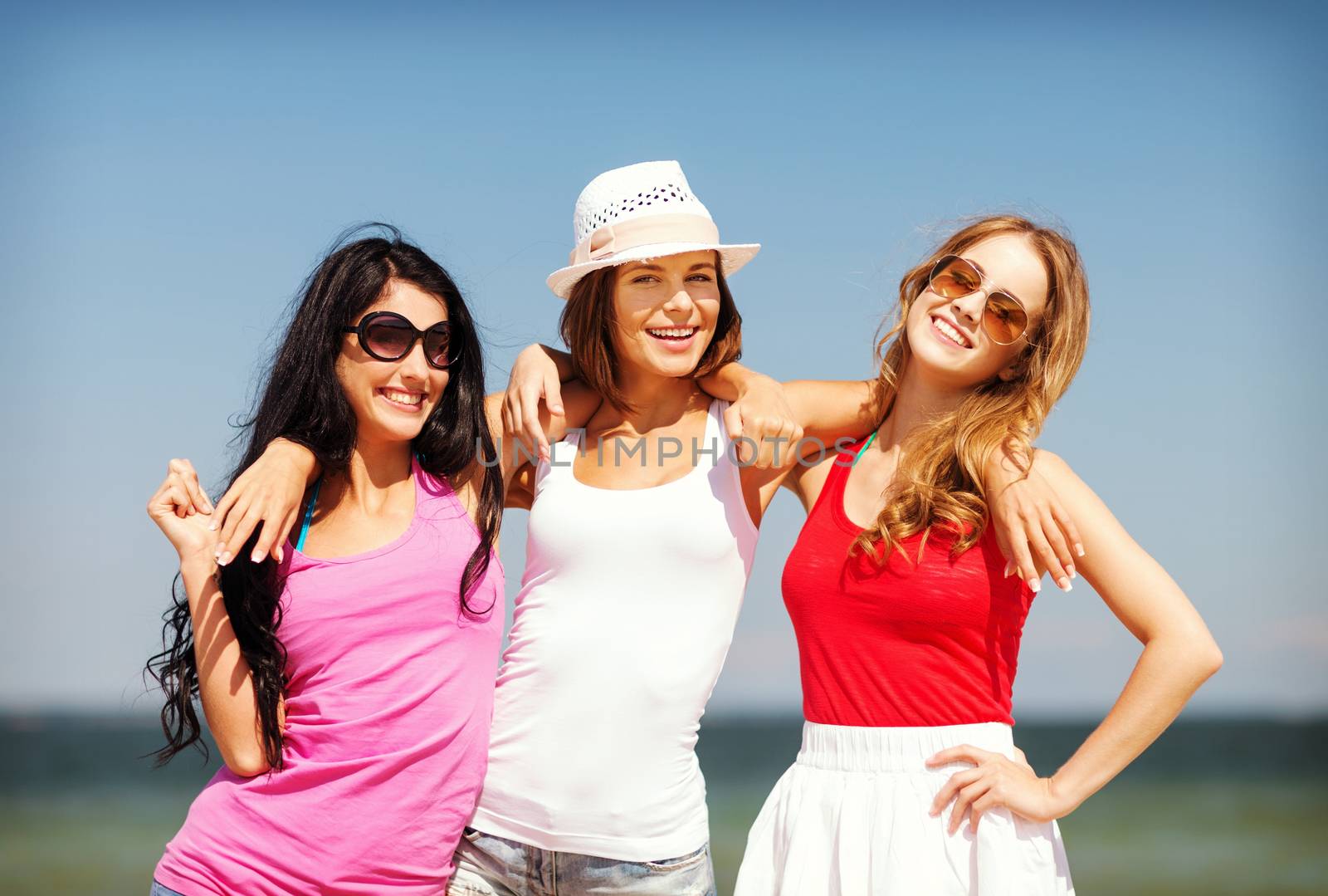group of girls chilling on the beach by dolgachov