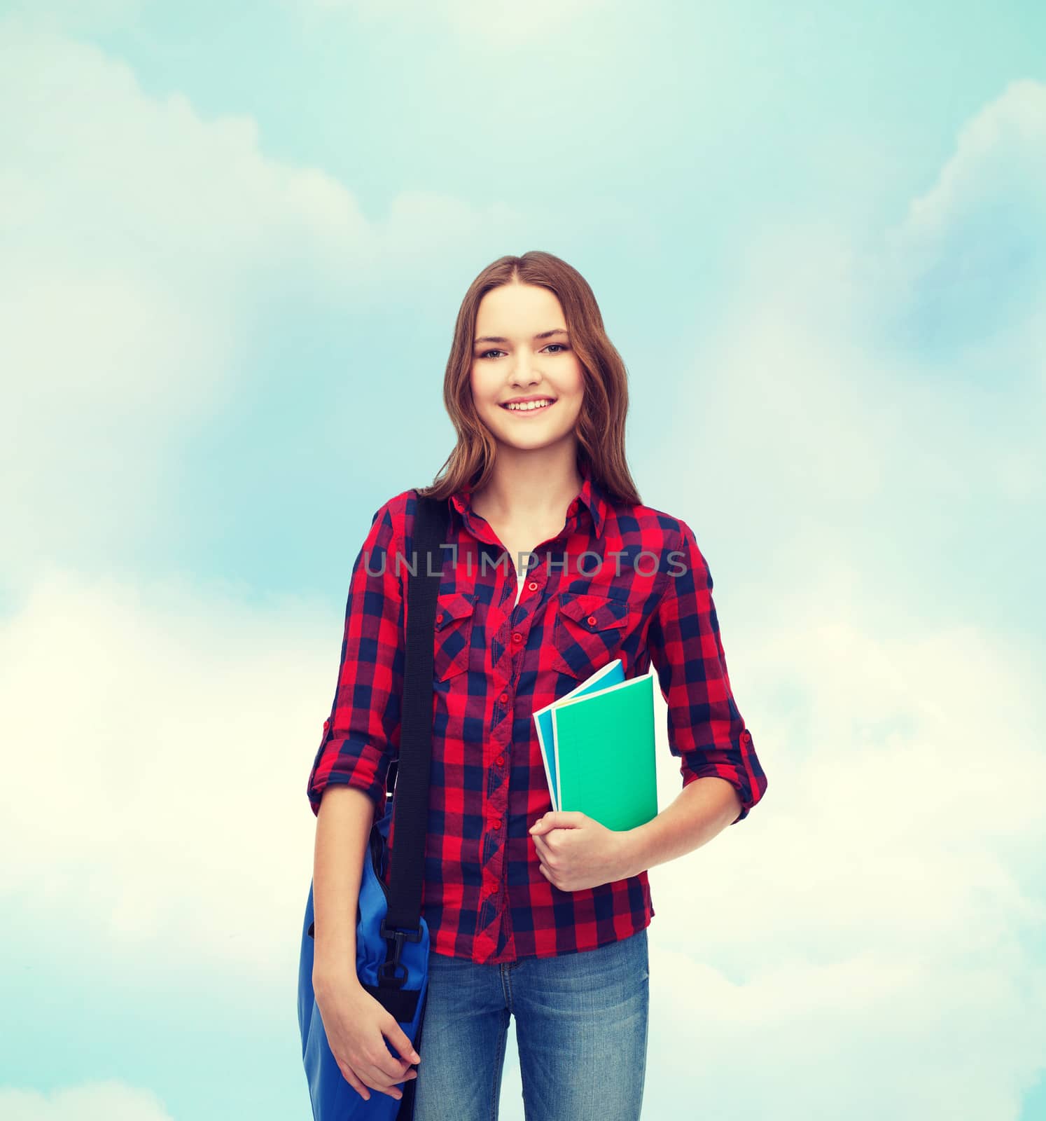 smiling female student with bag and notebooks by dolgachov