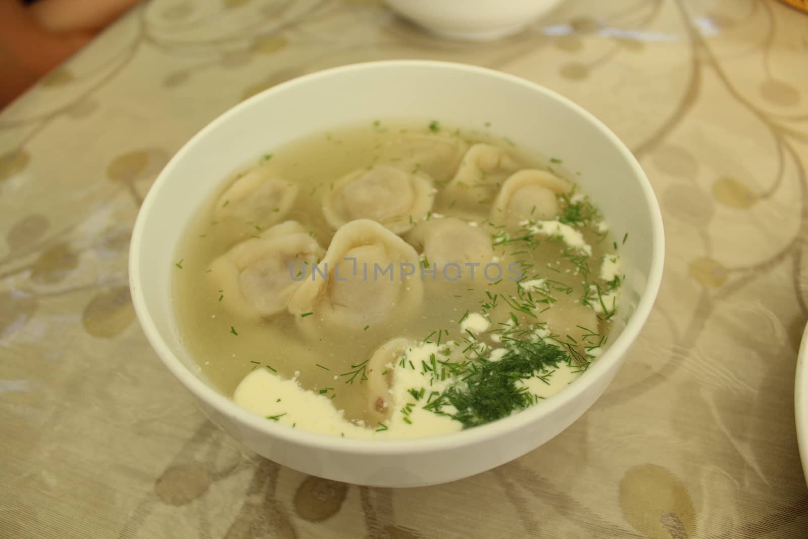 Meat dumplings with crushed herbs on top.