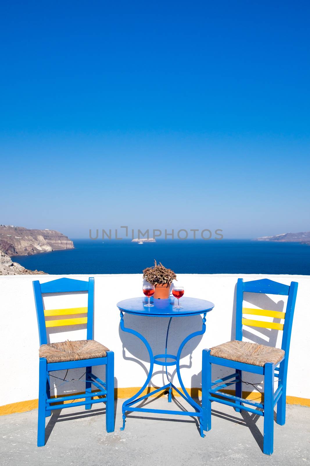 Blue chairs and table on a mediterranean balcony with nice view by martinm303