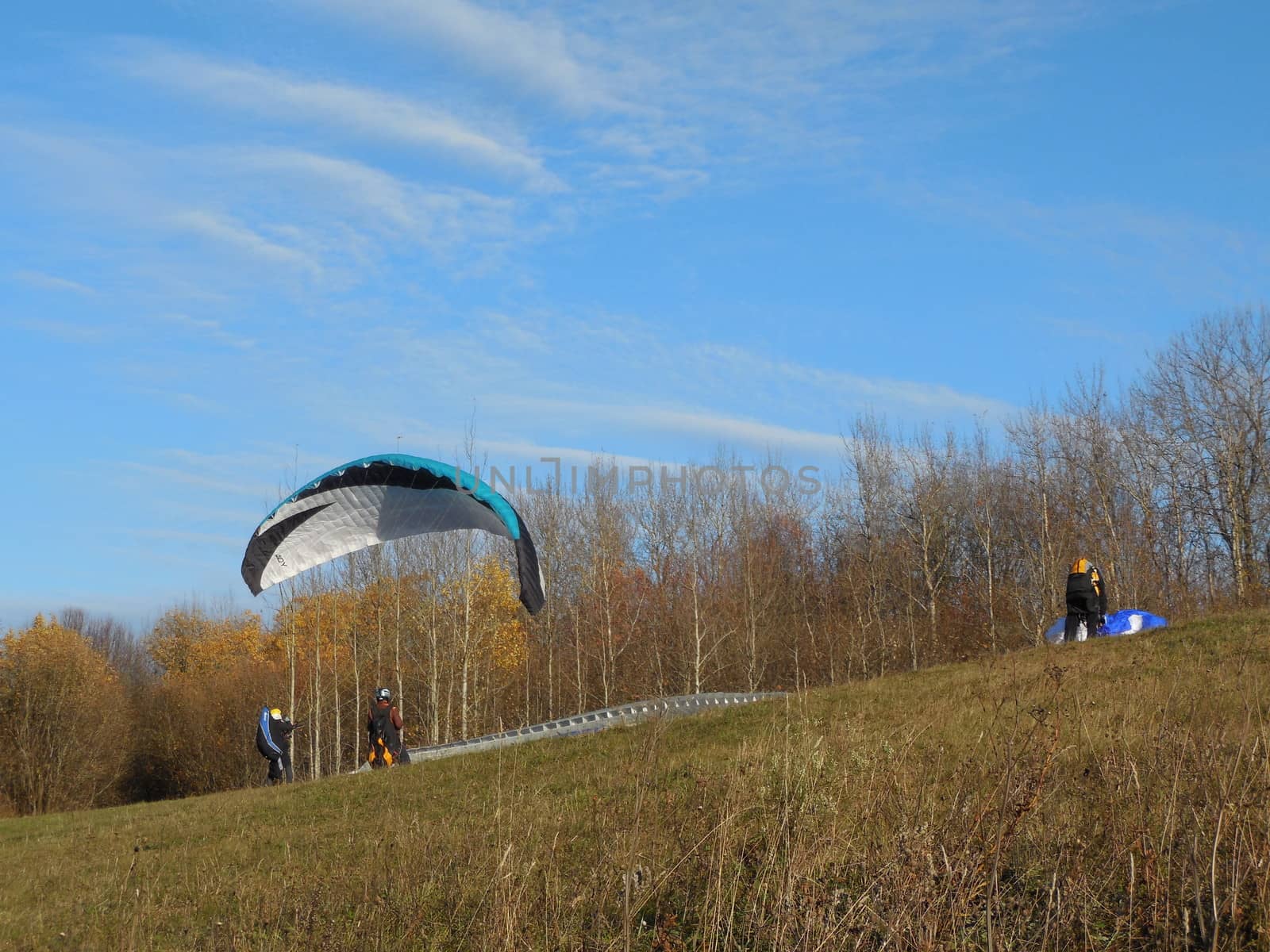 paragliders preparing for paragliding by olga_ovchinnikova