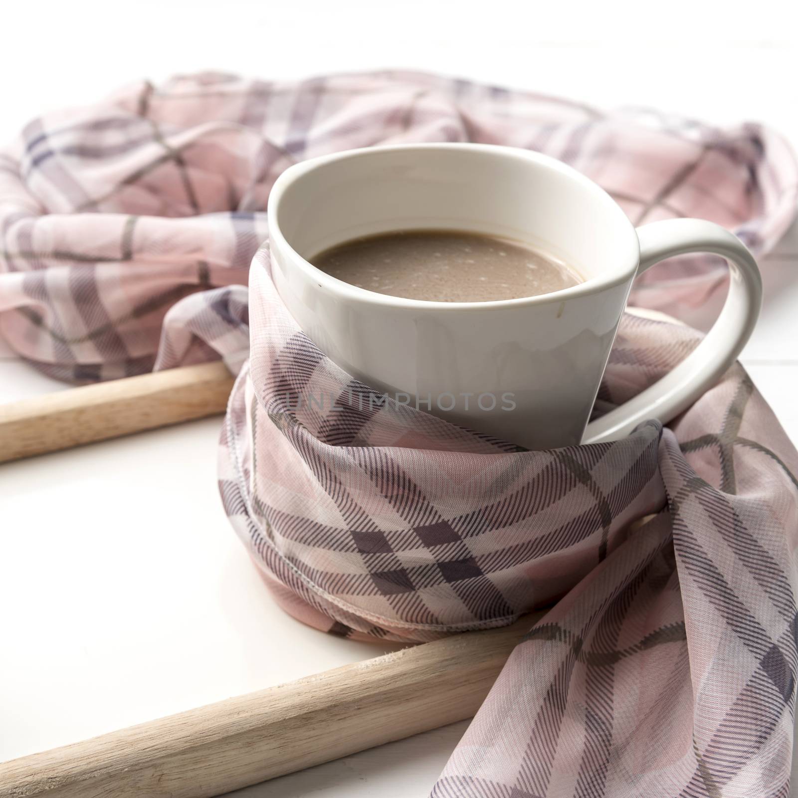 coffee and scarf background on white table