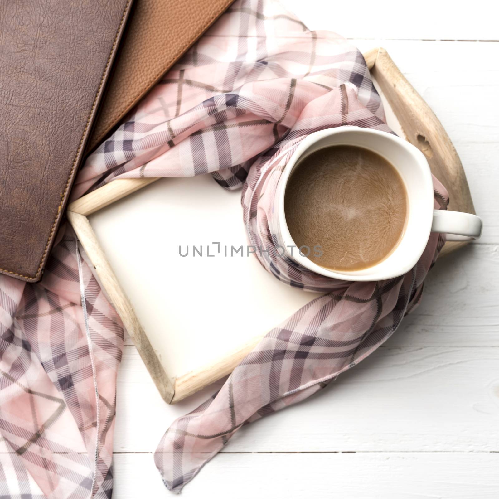 coffee and scarf background on white table