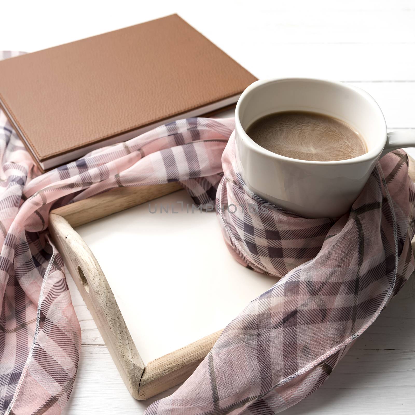 coffee and scarf background on white table