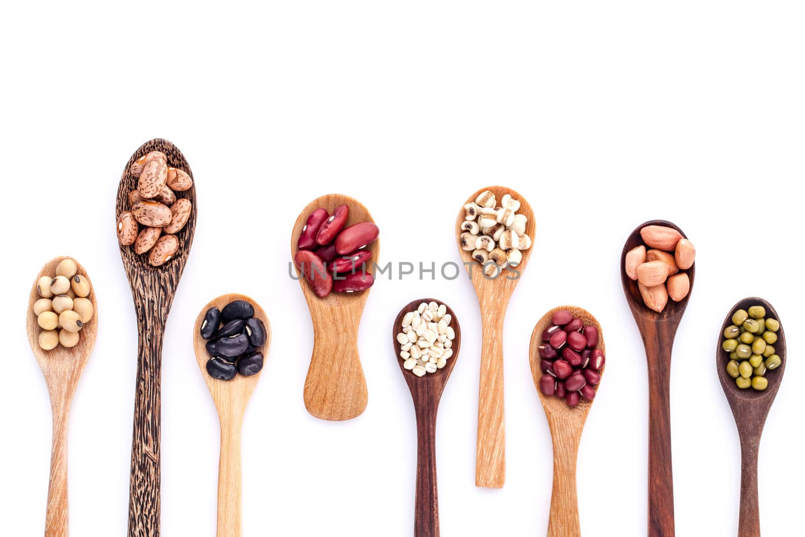 Assortment of beans and lentils in wooden spoon isolate on white  background. mung bean, groundnut, soybean, red kidney bean , black bean ,red bean and brown pinto beans .