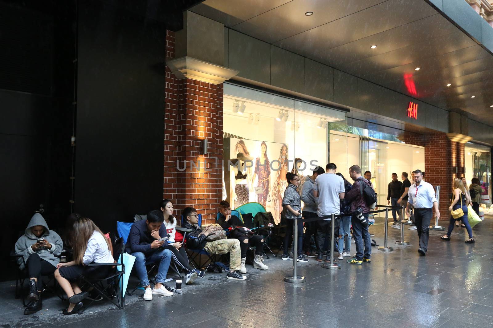 AUSTRALIA, Sydney: A queue forms outside the H&M store in Pitt Street Mall, Sydney on November 4, 2015 ahead of the official launch of the Balmain X H&M fashion range on November 5, 2015.